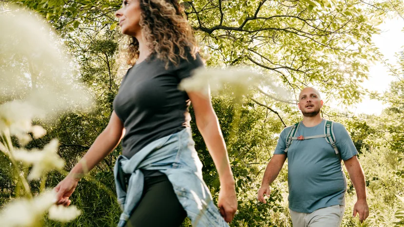 Couple going for a hike through the woods.