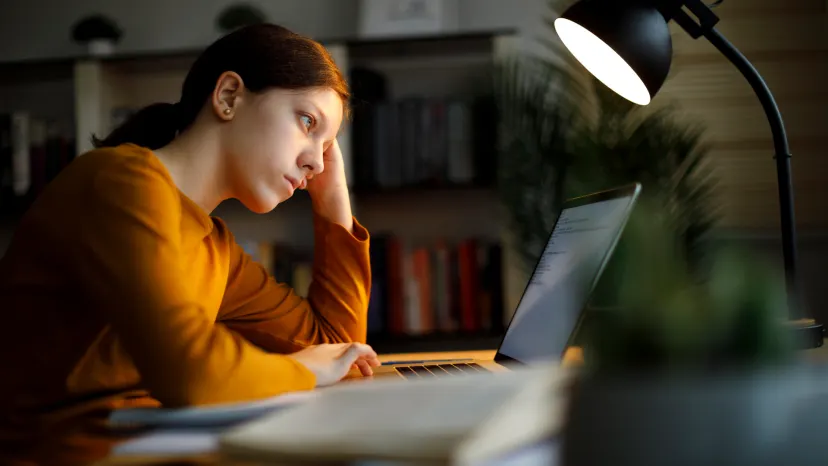 Young woman stressing out over work, which is a trigger for psoriasis.