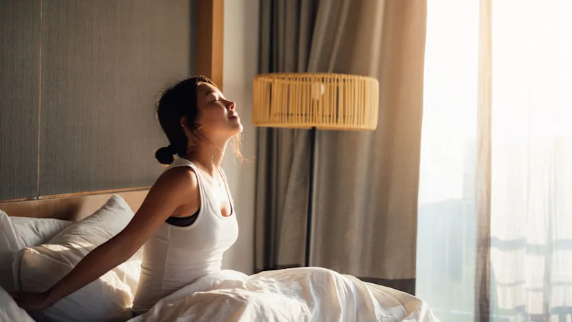 Woman with a sleep disorder waking from a restful night of sleep