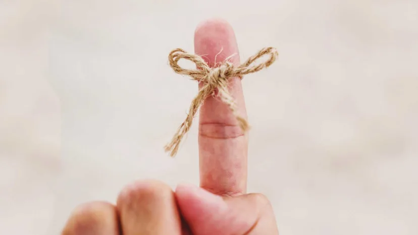 Finger with a string tied around it.
