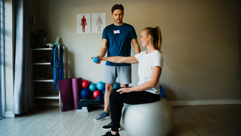 Young woman with multiple sclerosis training with a personal trainer.