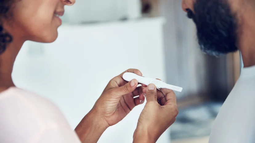 Couple checking the results of their at-home pregnancy test.