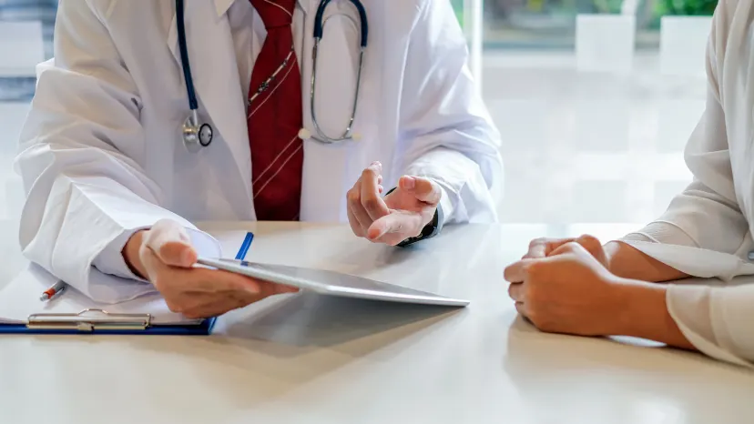 Closeup of woman with fibromyalgia sitting with her doctor discussing treatment options