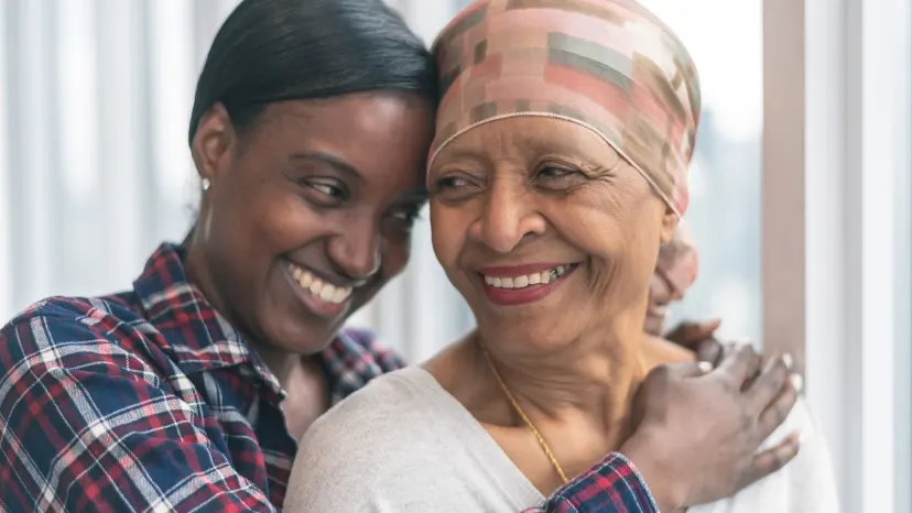 Mature woman with leukemia hugging her daughter