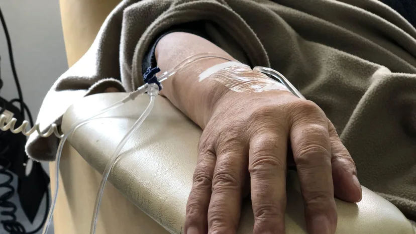 Closeup of the arm of a senior woman going through chemotherapy treatment