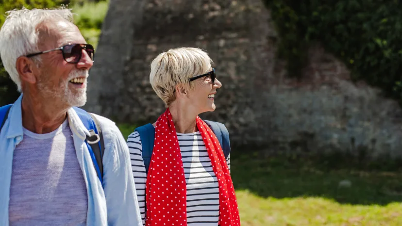 senior couple wearing protective eyeglasses on an outdoor walk to prevent glaucoma