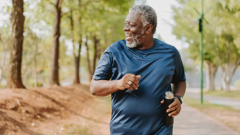 Smiling mature man running in a park to promote good health and prevent prediabetes