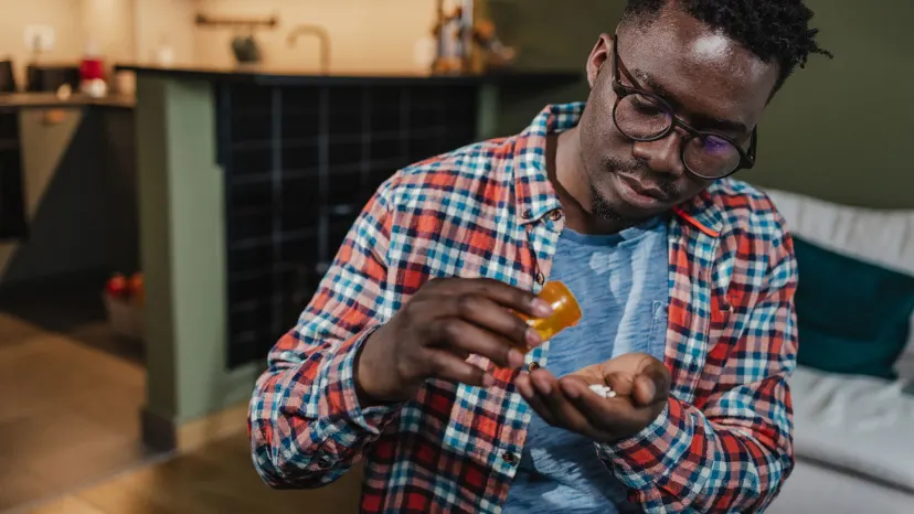 Man taking oral medication to treat acne