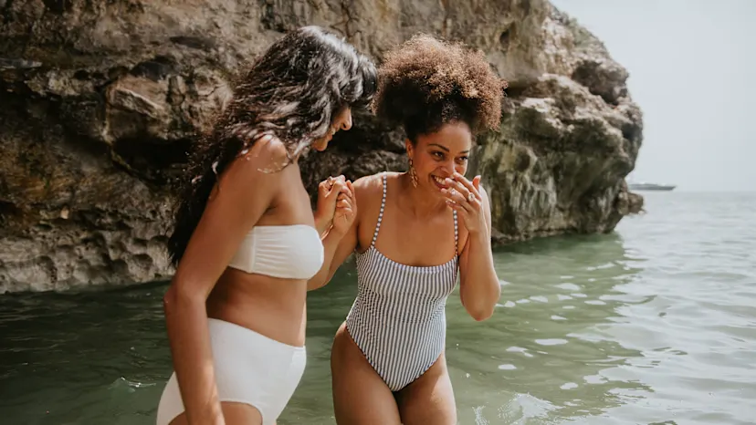Two women laughing at the beach 