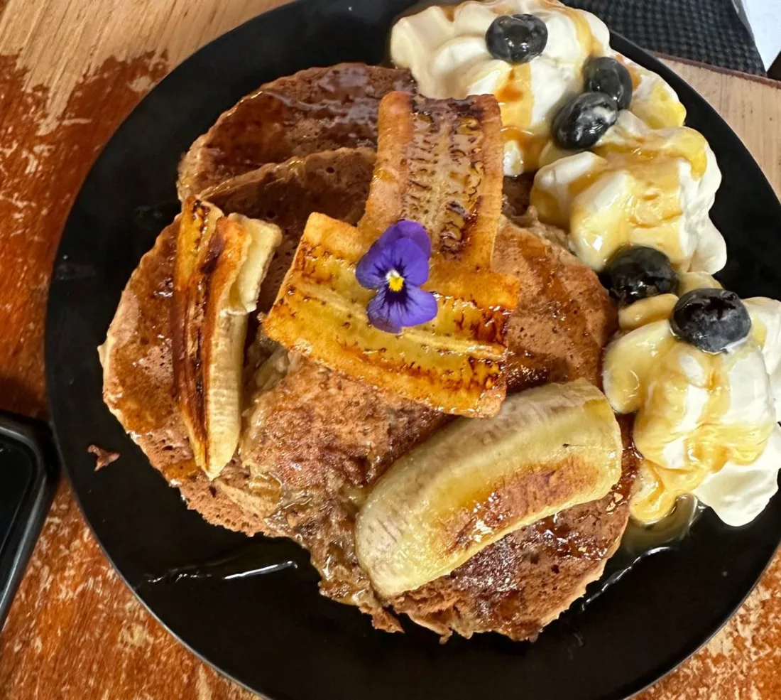 Een bord met pancakes en gekarameliseerde banaan