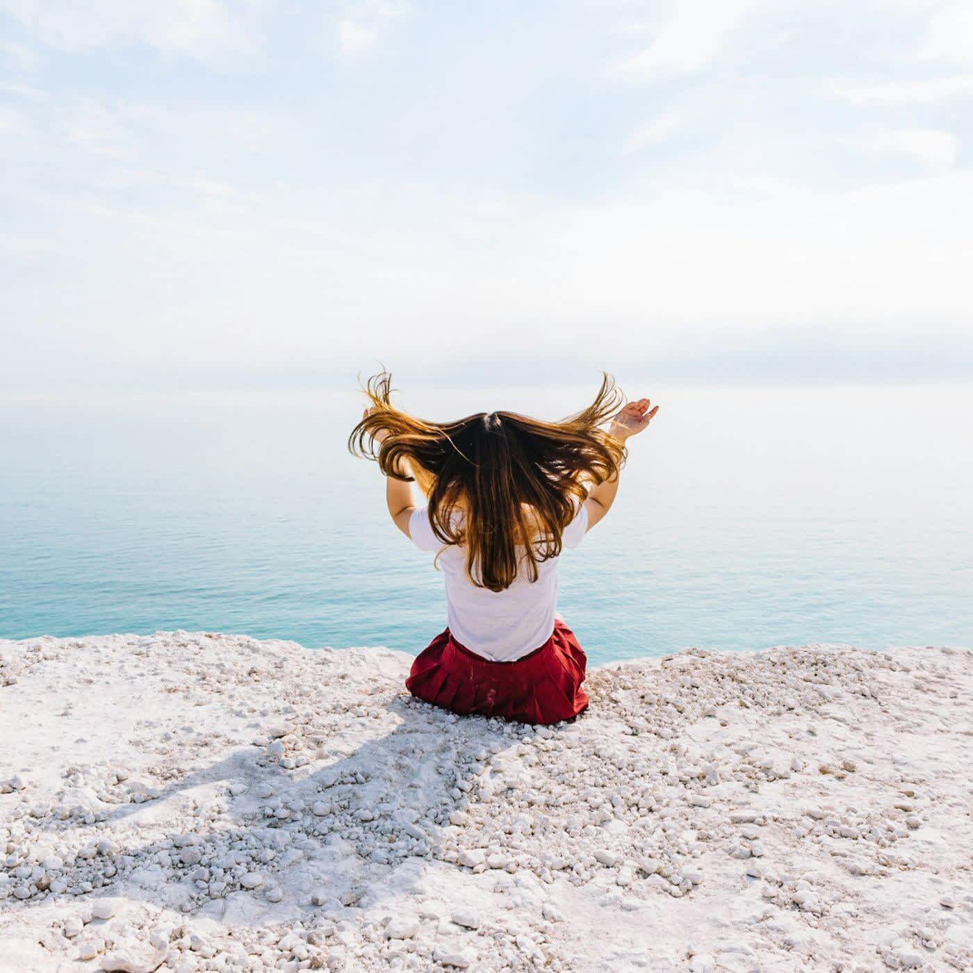 Back view of woman looking out to sea