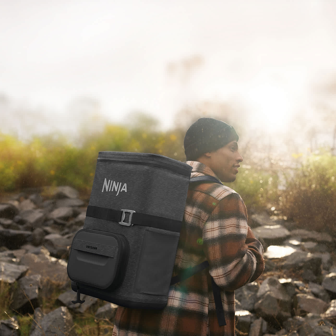 Image of a women outdoors wearing a Ninja FrostVault Go cooler backpack.