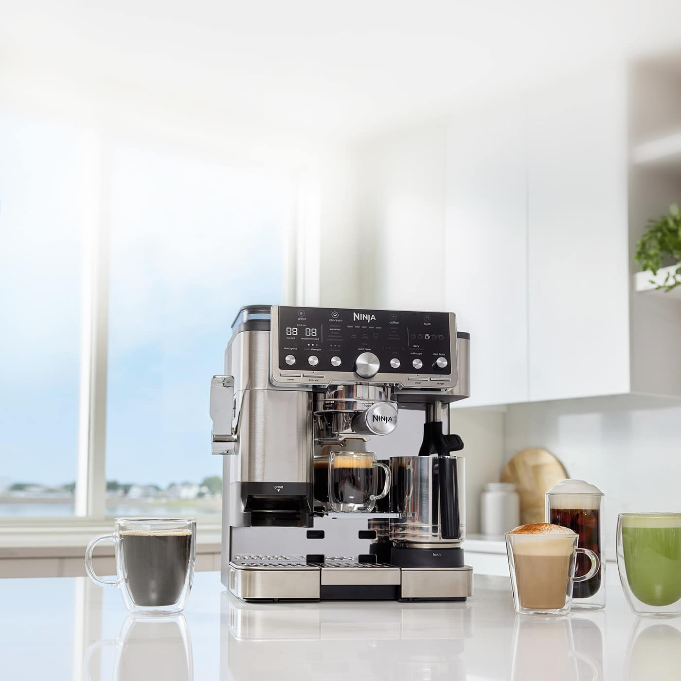 Image of Ninja Luxe Café Pro Espresso Machine on a kitchen counter with coffee drinks.