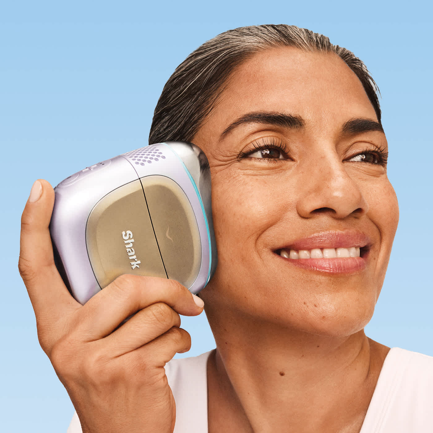 Side-by-side before and after of a woman with curly hair transformed into sleek, smooth straight hair using a gold flat iron.