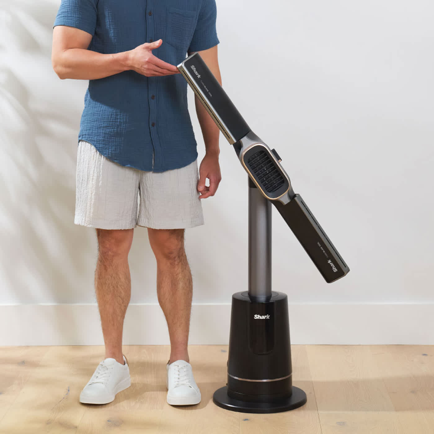 A man holding the Shark Turbo Blade Cool + Heat Fan