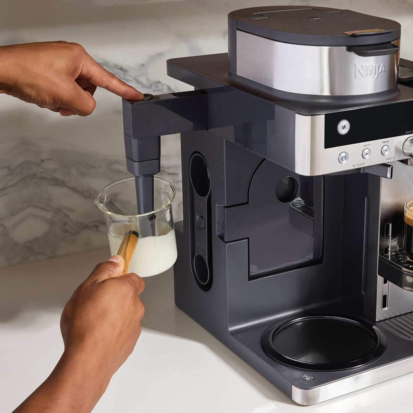 Built-in, fold-away milk frother