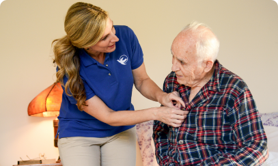 A Visiting Angels caregiver engaging with an elderly man outdoors, highlighting the warmth of in-home care services.