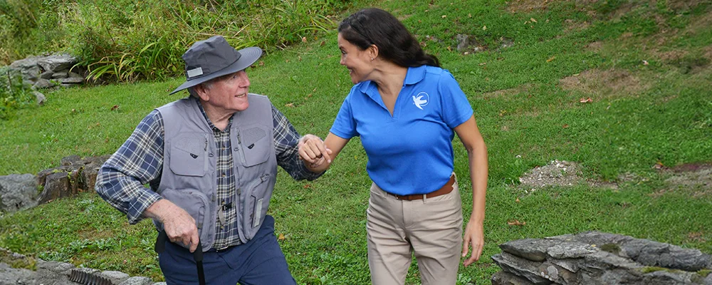 A Senior Home Care by Angels caregiver comforting an elderly woman with Alzheimer's, highlighting compassionate support in a peaceful home setting.