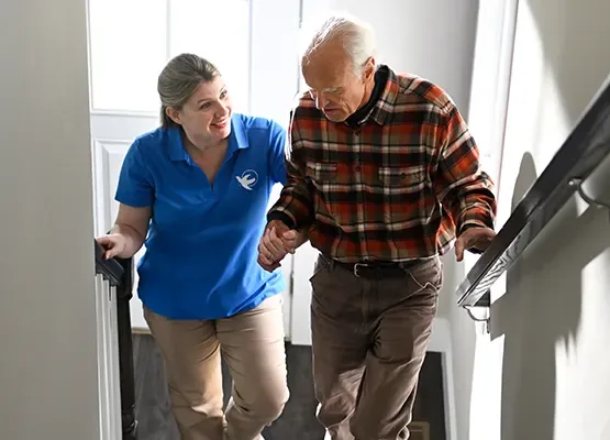 A Senior Home Care by Angels caregiver comforting an elderly woman with Alzheimer's, highlighting compassionate support in a peaceful home setting.