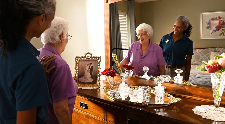 A Senior Home Care by Angels caregiver assisting an elderly woman.