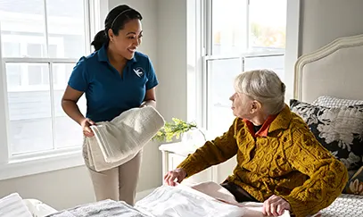 Caregiver providing home care services to support a senior at home