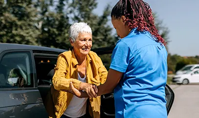 Caregiver assisting a senior through the Ready, Set, Go Home program for a safe transition after hospital discharge
