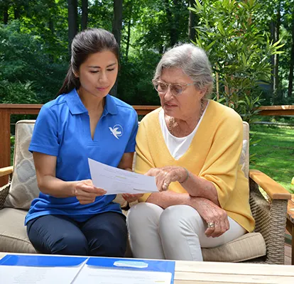 A Senior Home Care by Angels caregiver comforting an elderly woman with Alzheimer's, highlighting compassionate support in a peaceful home setting.