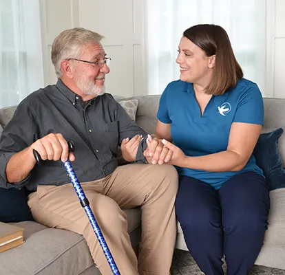 A Senior Home Care by Angels caregiver comforting an elderly woman with Alzheimer's, highlighting compassionate support in a peaceful home setting.