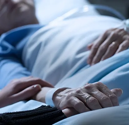 A Senior Home Care by Angels caregiver comforting an elderly woman with Alzheimer's, highlighting compassionate support in a peaceful home setting.