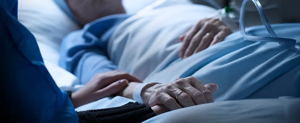 A Senior Home Care by Angels caregiver comforting an elderly woman with Alzheimer's, highlighting compassionate support in a peaceful home setting.