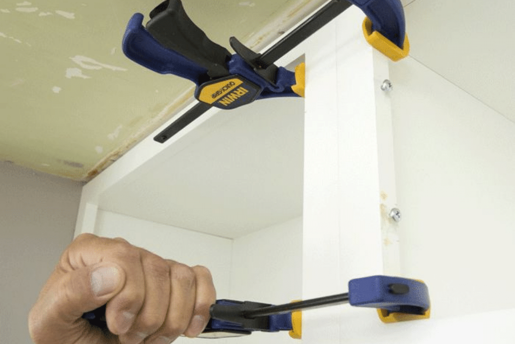 pipe and bar clamps joining the cabinets