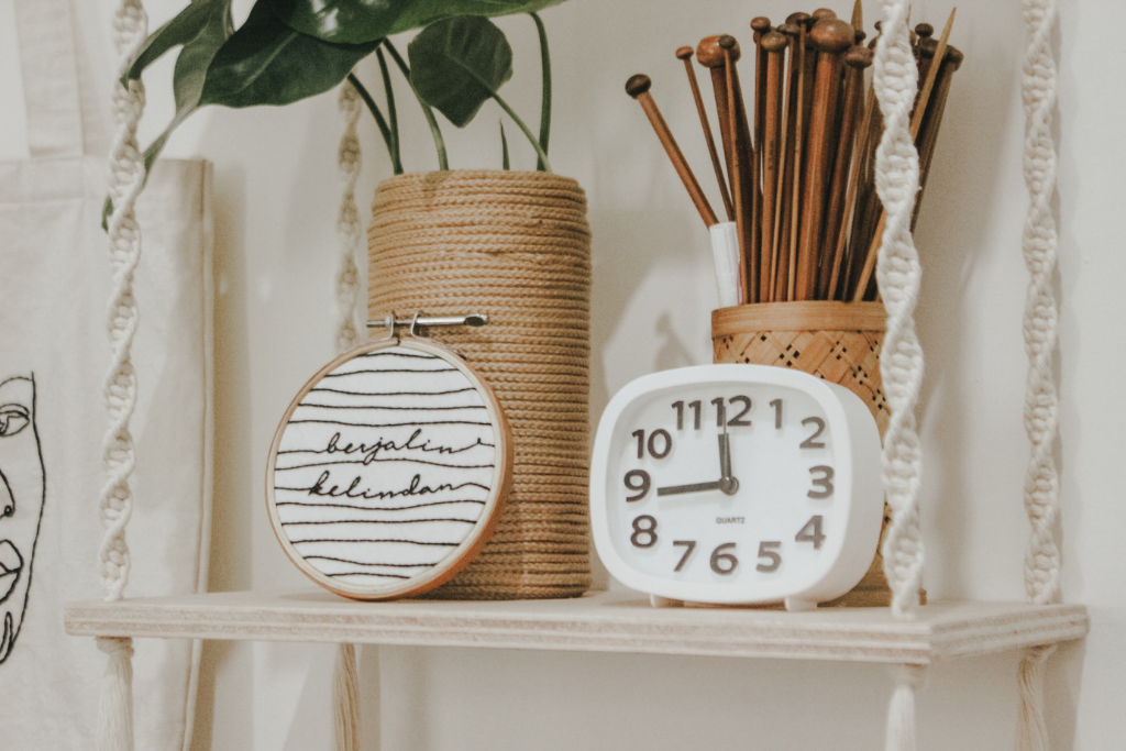 white macrame wall-hanging shelf with ornaments