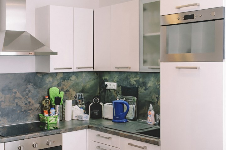 white wooden kitchen cabinet with blue and white electric kettle