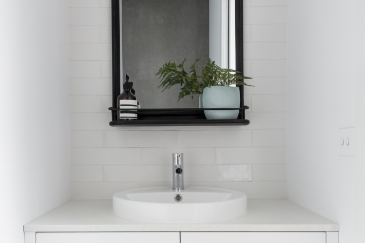 white sink and black mirror powder room idea