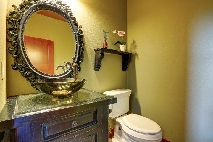 bronze bathroom with Grecian mirror