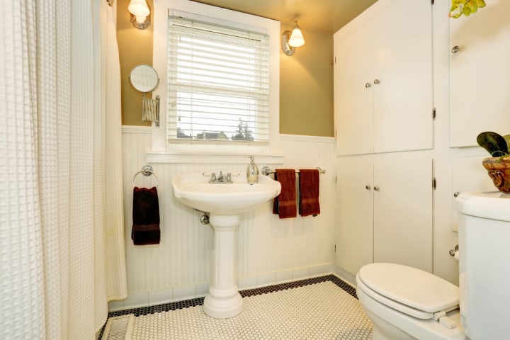 bathroom with full-size cabinet on the wall