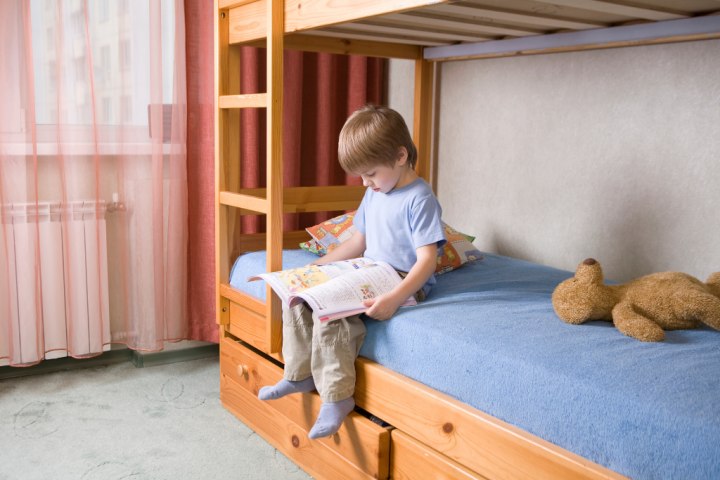Boy on wood bunk bed for storage ideas for small spaces
