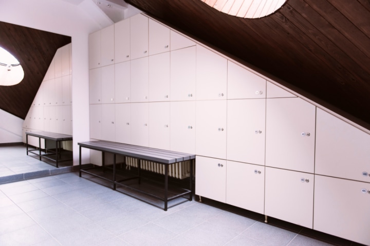  White lockers line wall of room. 