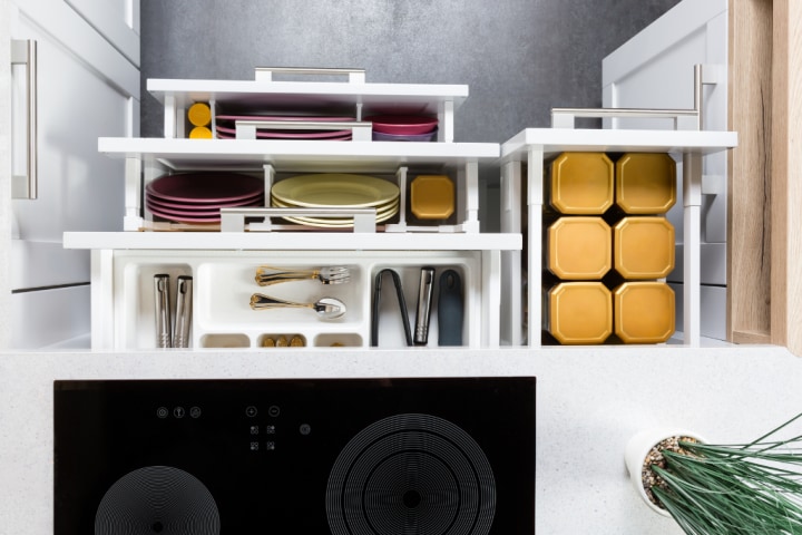 Modern kitchen drawers organized with dividers to separate utensils, cookware, and storage