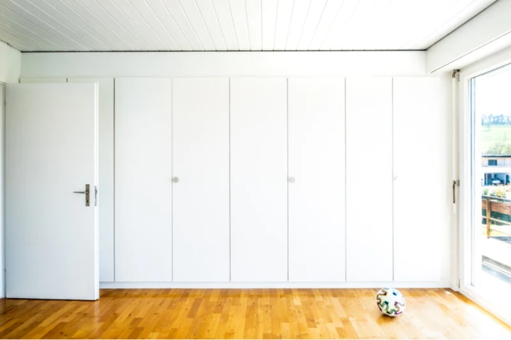 white bi fold doors part of built-in closet ideas