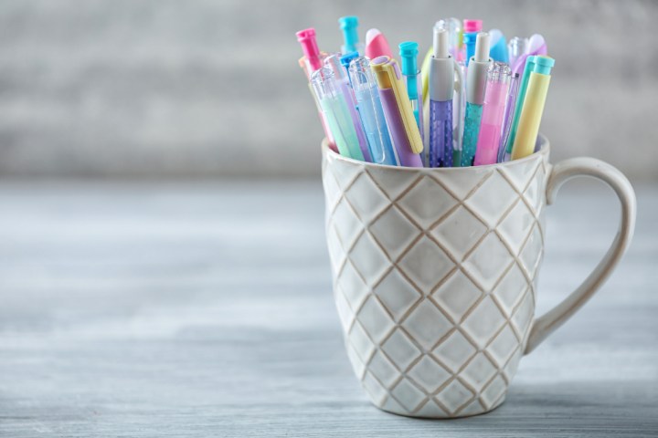 Ceramic cup filled with colored pens and reuse them for home office storage ideas