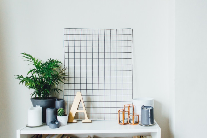  A white home office with a wire trellis board for home office storage ideas