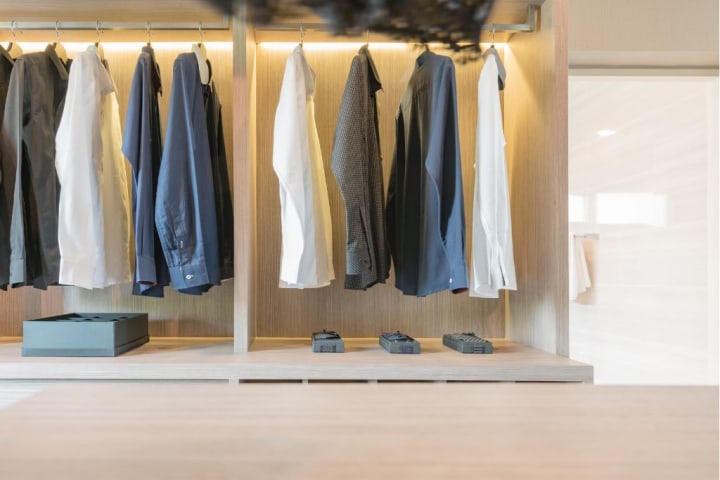 Clothes-hanging-in-wooden-walk-in-closet.jpg