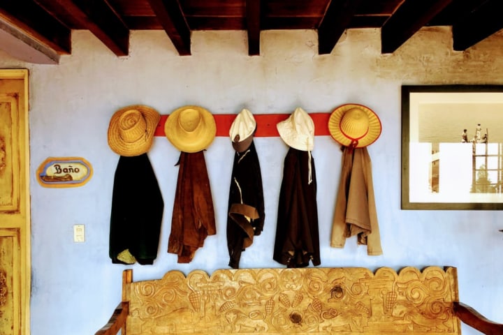 Clothes and hats hanging on the wall