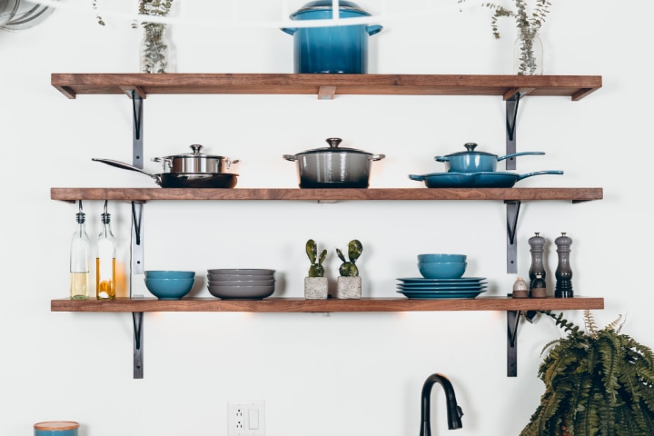 Floating shelves with pots and pans and other kitchenware