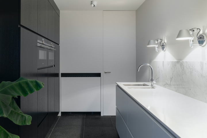 Minimalist kitchen with multiple cabinets and shelving units