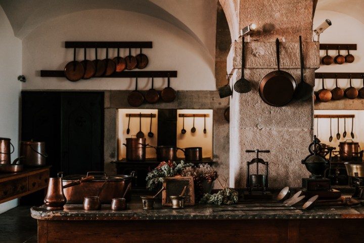 Vintage look kitchen with hanging rods for pots and pans