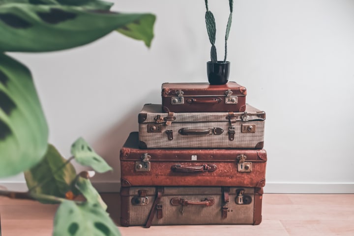 Storage trunks, suitcases, and briefcases can be a functional design statement as a living room storage idea.