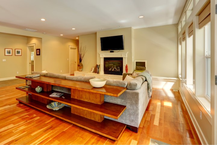 Console tables add flair and storage to an open space plan where the couch isn’t positioned directly in front of a wall.