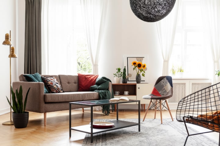 Furniture with tall legs draws the focus of the room up rather than wide